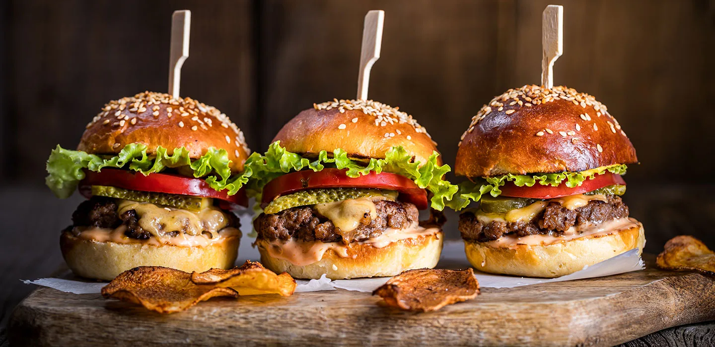 Three sliders on a wood board
